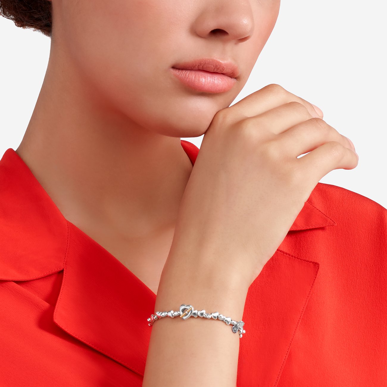 DoDo armband van 925 zilver met hartvormige hanger en goudkleurige staaf.