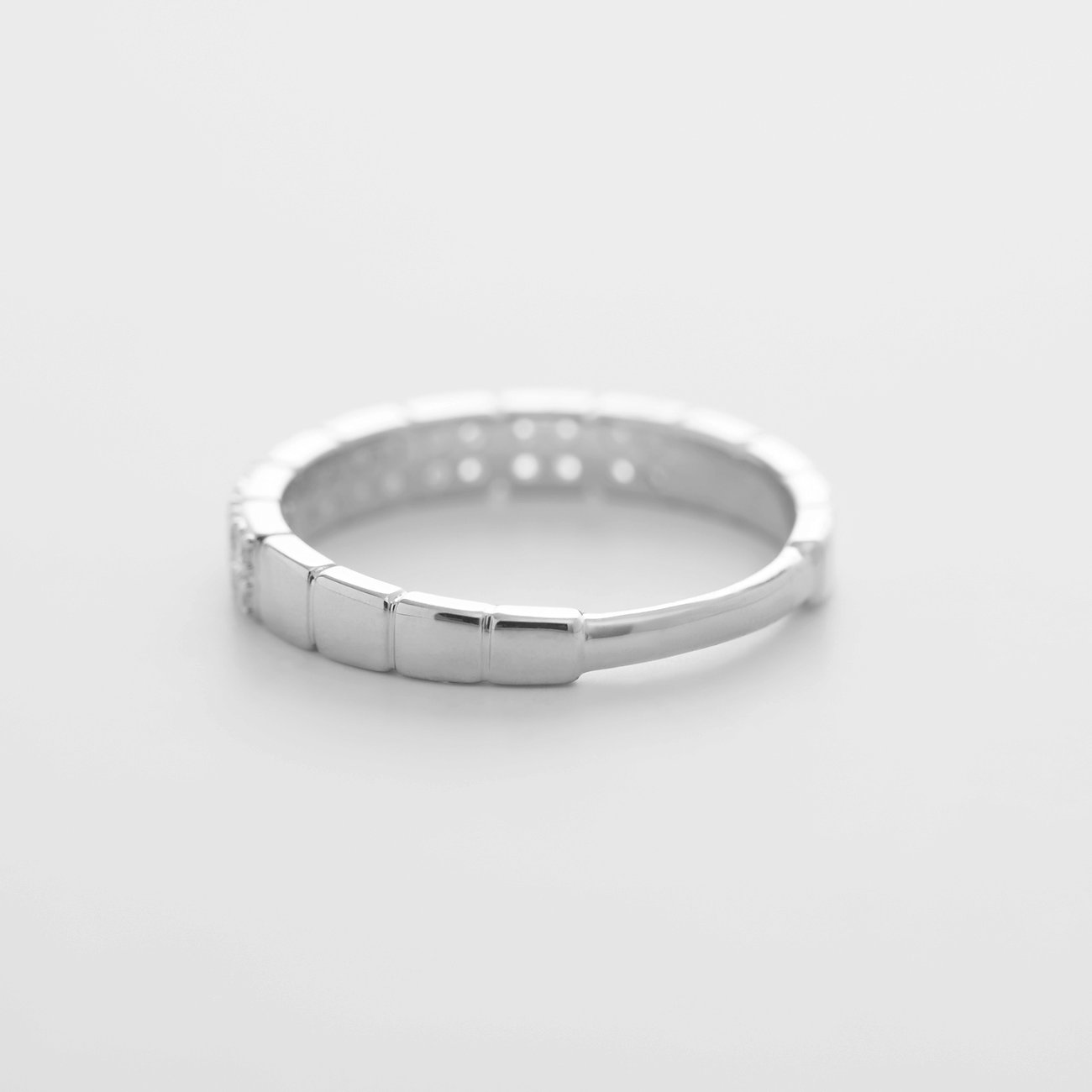 En CHRIST ring i 585 vitguld, med gnistrande diamanter, som ligger lätt snett på en vit yta.