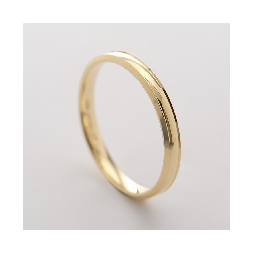 Close-up van een CHRIST ring van geelgoud, 375 legering, met een subtiele gebogen groef aan de bovenzijde.