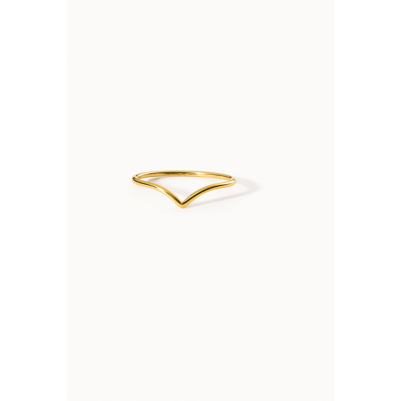 Een delicate gouden Purelei ring van roestvrij staal in V-vorm, centraal geplaatst op een lichte achtergrond.