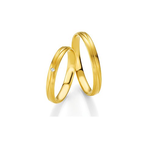 CHRIST Trauringe aus Gelbgold mit Steinbesatz und Rillenmuster.