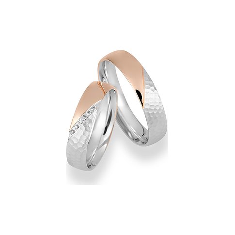 CHRIST Trauringe aus bicolor Gold mit geschwungenen Elementen und Diamanten.