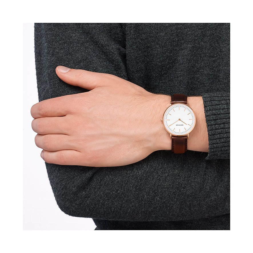 Bering Herrenuhr aus Edelstahl mit braunem Lederband an einem Arm.