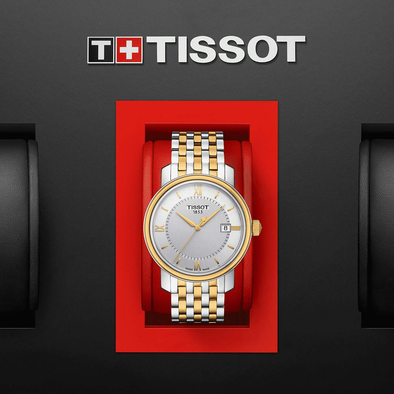Tissot Herrenuhr aus Edelstahl in Silber und Gold in einer roten Verpackung von oben gesehen.