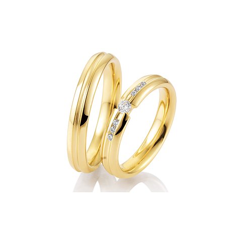 CHRIST Trauringe aus Gelbgold mit Brillanten und Rillenmuster.