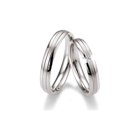 CHRIST Trauringe aus Weißgold mit Steinbesatz und Rillenmuster.