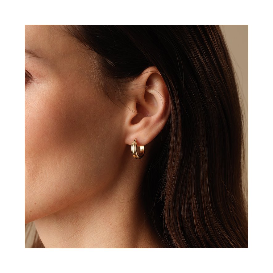 FAVS gouden creolen van geelgoud aan één oor gedragen, zichtbaar van opzij.