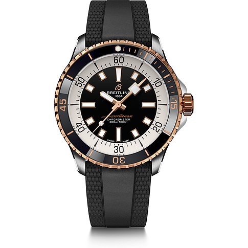 Breitling Herrenuhr aus Edelstahl und Rotgold mit schwarzem und weißem Zifferblatt und schwarzem Kautschukarmband.