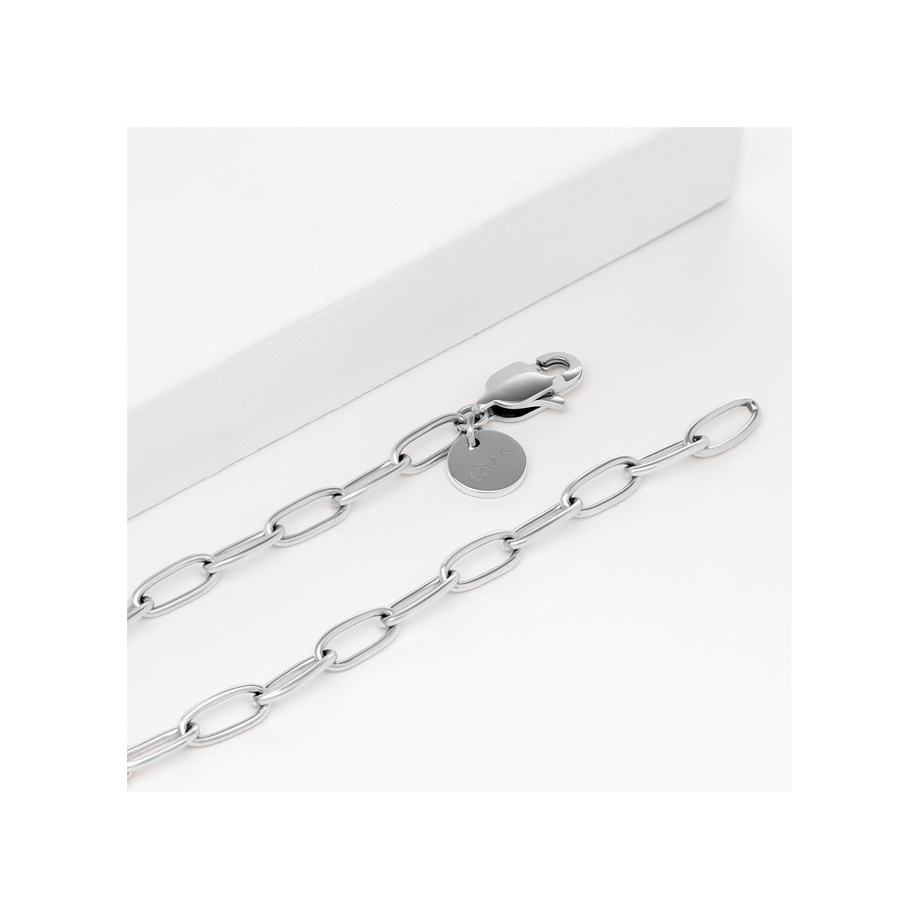 Das Guido Maria Kretschmer Armband aus poliertem Edelstahl zeigt eine Gliederkette mit ovalen Elementen.