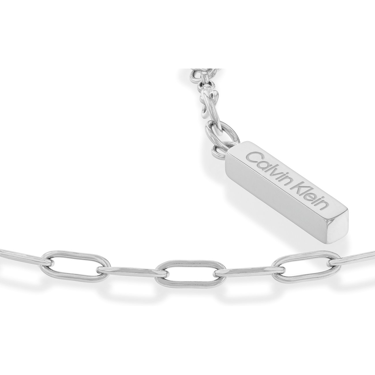 Nahaufnahme eines Calvin Klein Armbands aus Edelstahl mit einer Kette aus ovalen Gliedern und einem gravierten Etikett.