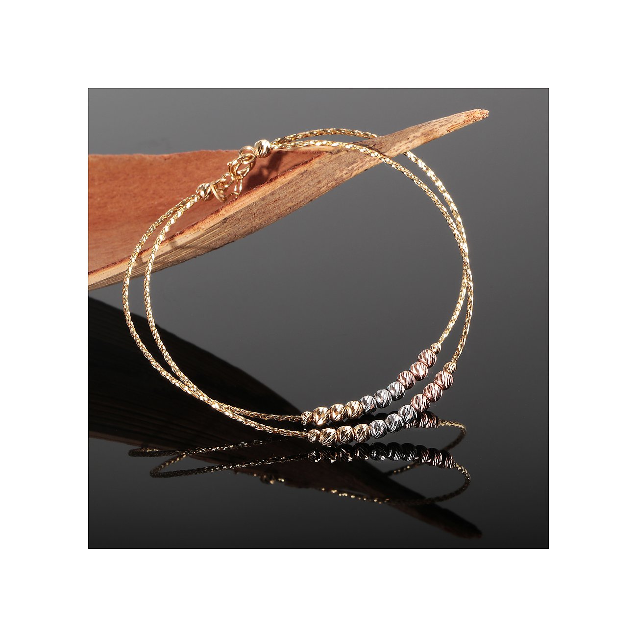 CHRIST armband van 585 geelgoud, witgoud en roségoud met facetparels.