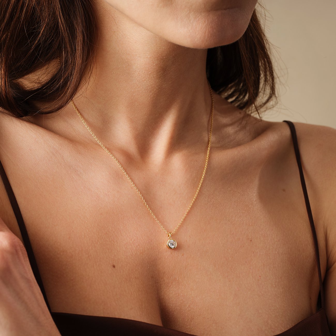 FAVS vergulde 925 zilveren ketting met een ronde zirkonia kleurstof hanger om de hals van een vrouw.