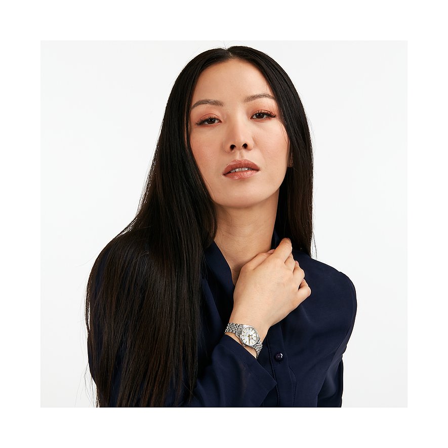 Donna con capelli neri lunghi indossa un orologio da donna Lucien Rochat in acciaio inox con diamanti.