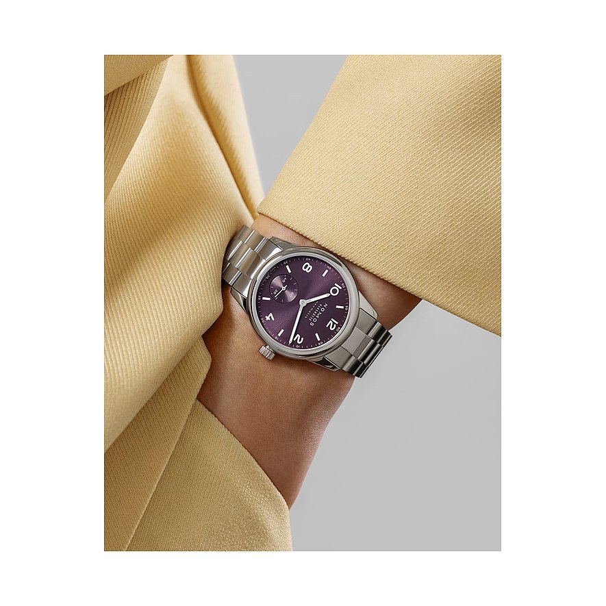 Nomos Glashütte Damenuhr mit Edelstahlgehäuse, lila Zifferblatt und silbernem Armband.