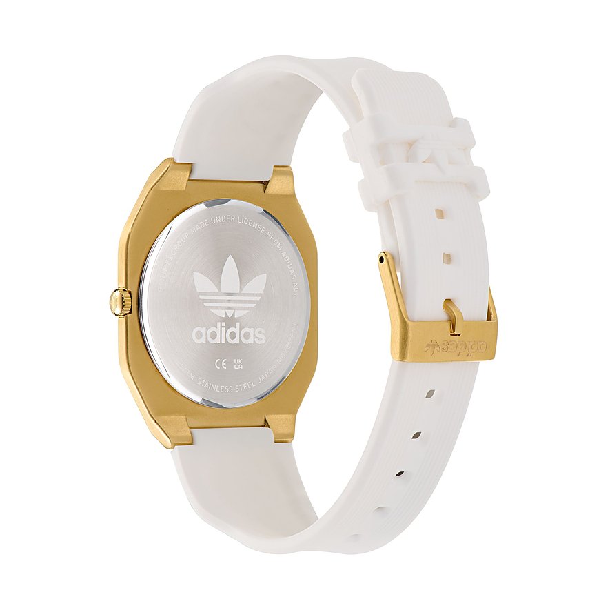 Montre unisexe Adidas avec boîtier en acier inoxydable, couleur or, et bracelet blanc.