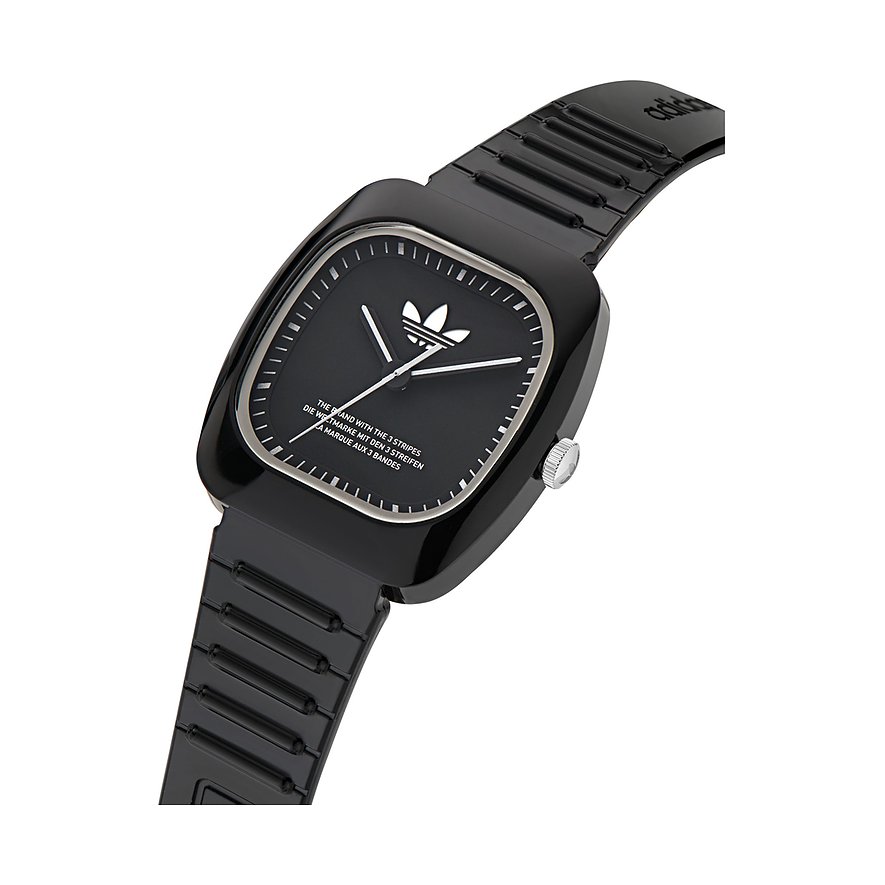 Montre unisexe Adidas avec boîtier en céramique, cadran noir et affichage analogique.