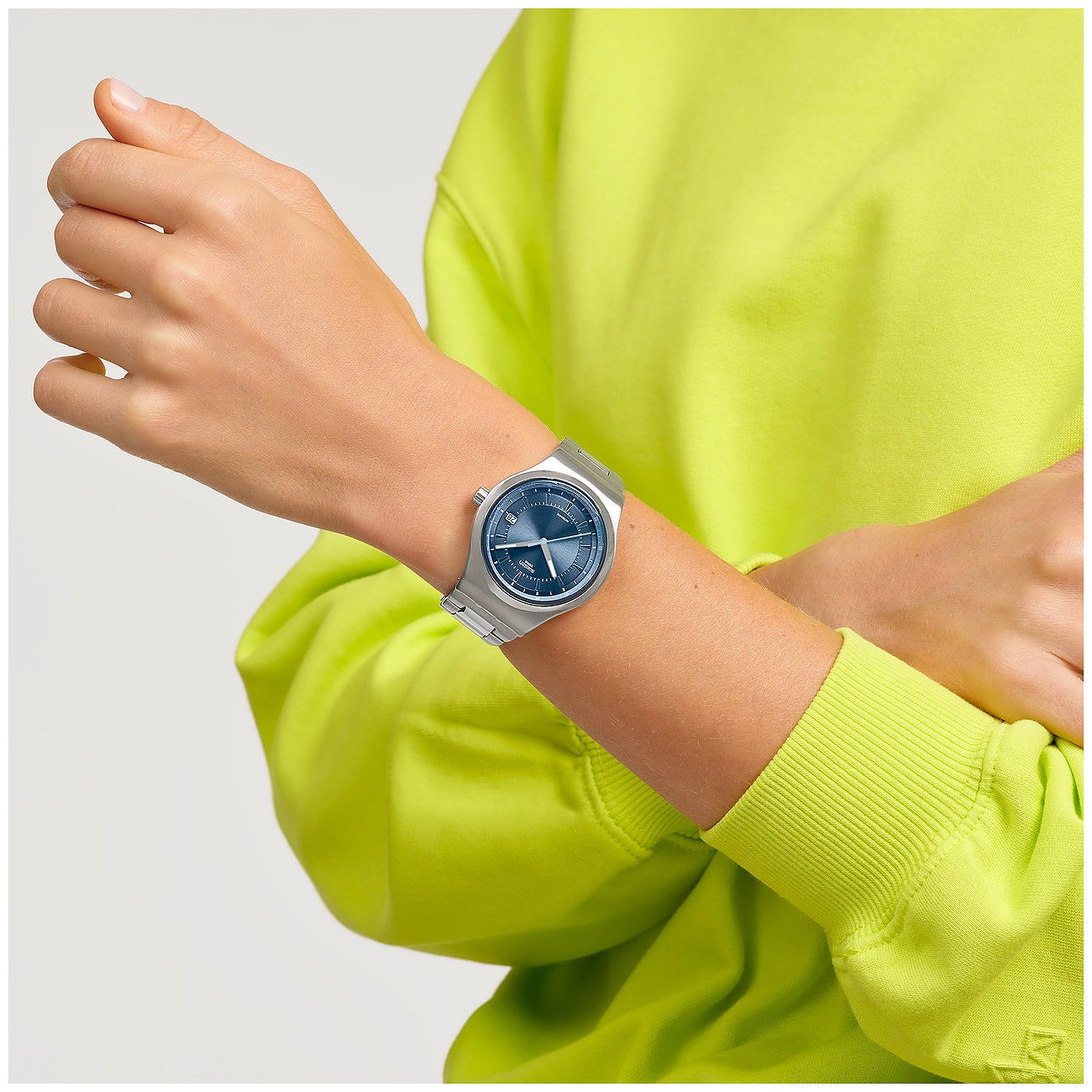 Montre unisexe Swatch avec boîtier en acier inoxydable, cadran bleu et bracelet argenté.
