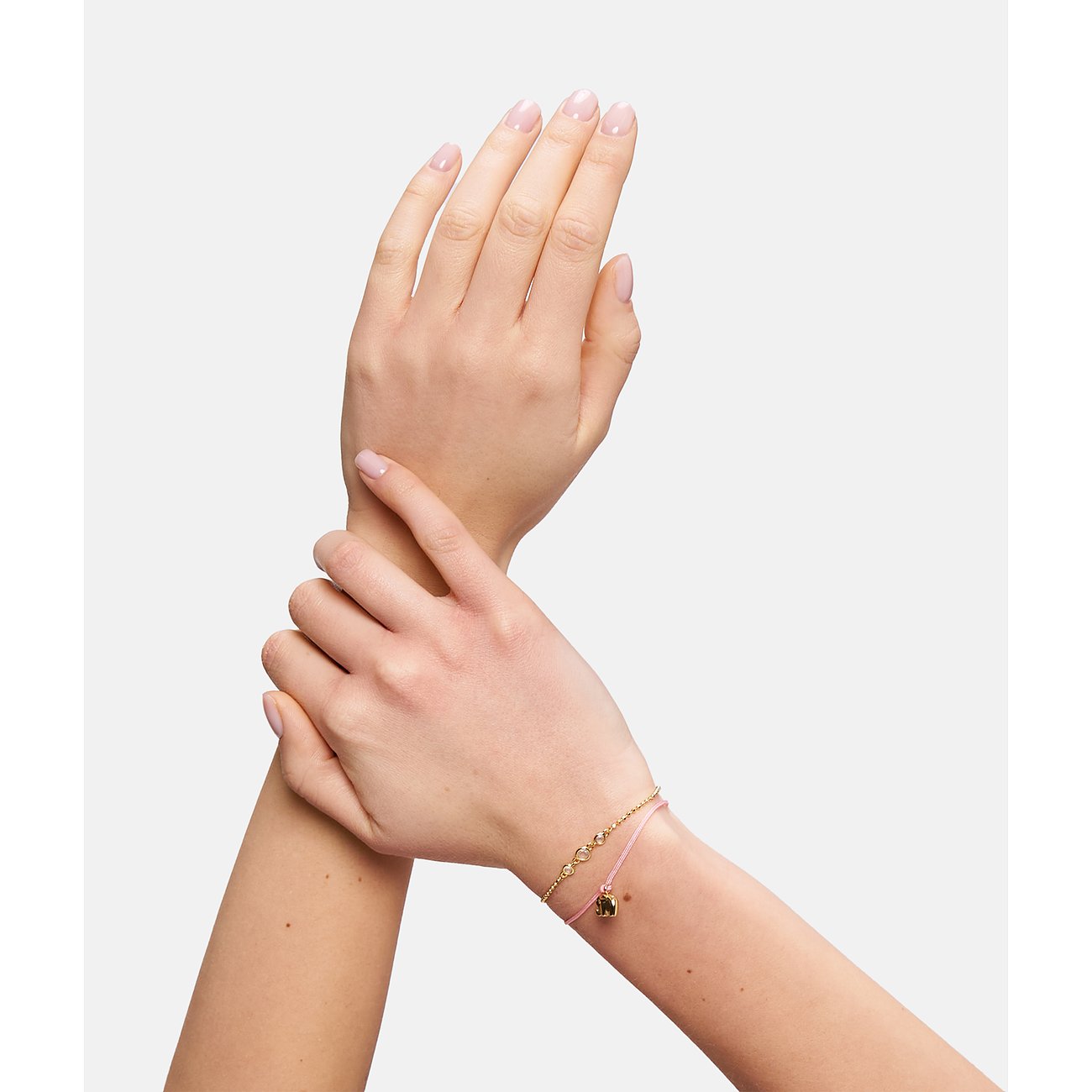 Tamaris Armband aus Edelstahl mit goldenem Elefantenanhänger und rosa Band.