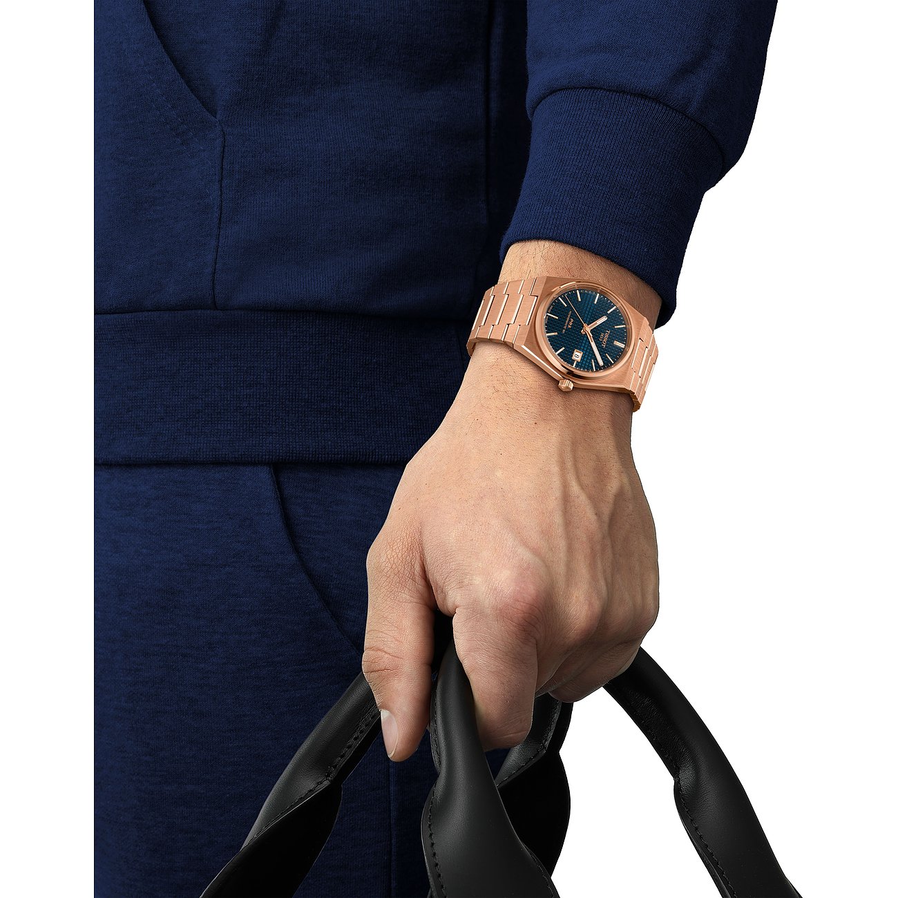 Tissot Herrenuhr mit roségoldfarbenem Gehäuse und blauem Zifferblatt.