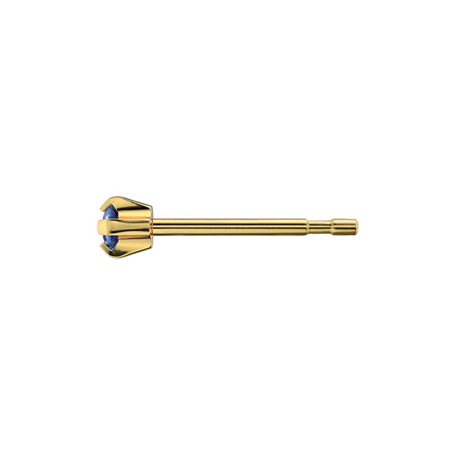 Ein goldfarbener Studex Ohrstecker aus Chirurgenstahl mit einem blauen Stein, seitlich aufgenommen.