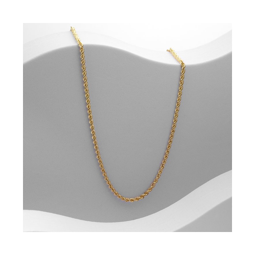 CHRIST collier: Een gouden CHRIST collier van 585 geelgoud ligt op een lichtgrijze, golvende ondergrond.