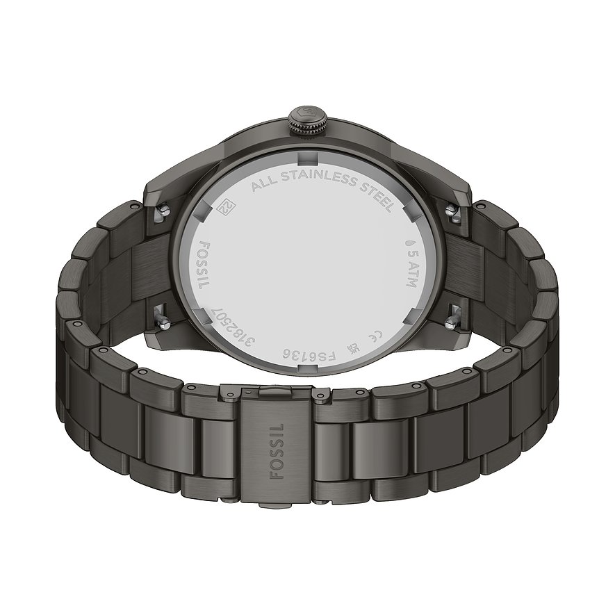 Baksidan av en Fossil herrklocka i mörkgrått rostfritt stål med graverade detaljer på boettlocket.