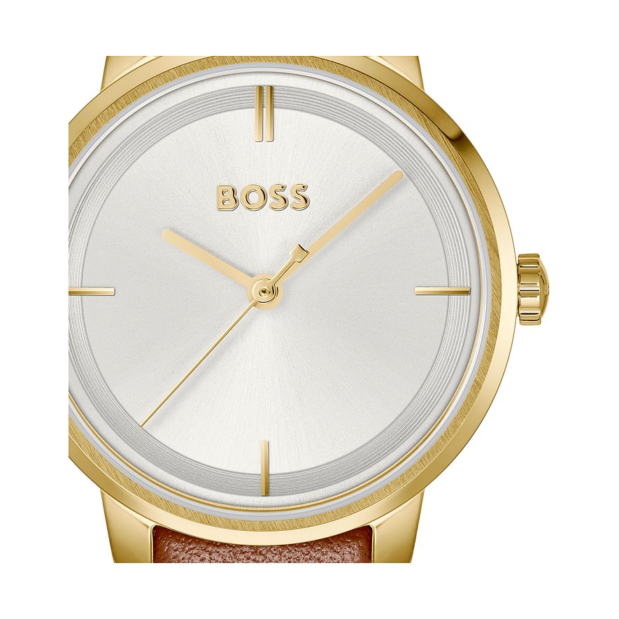 Close-up van een Boss dameshorloge van goudkleurig roestvrij staal met een witte wijzerplaat en gouden wijzers.