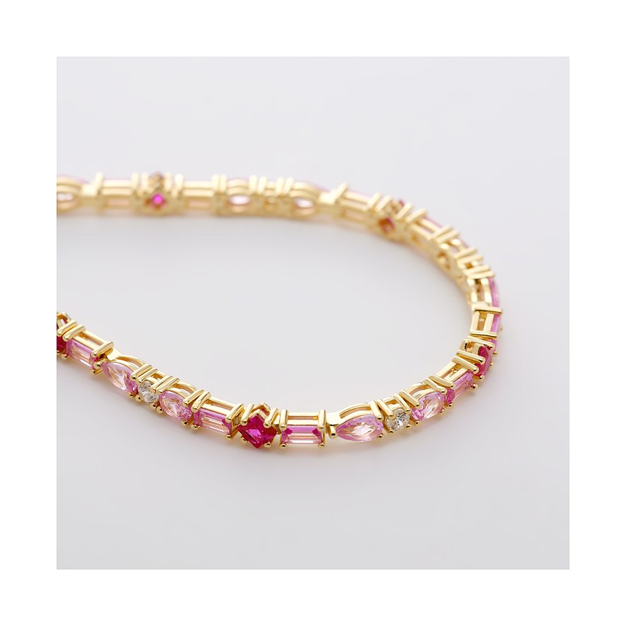 Nahaufnahme eines goldfarbenen Armbands von CHRIST aus recyceltem 925er Silber mit rosa und roten Zirkonia Farbsteinen.