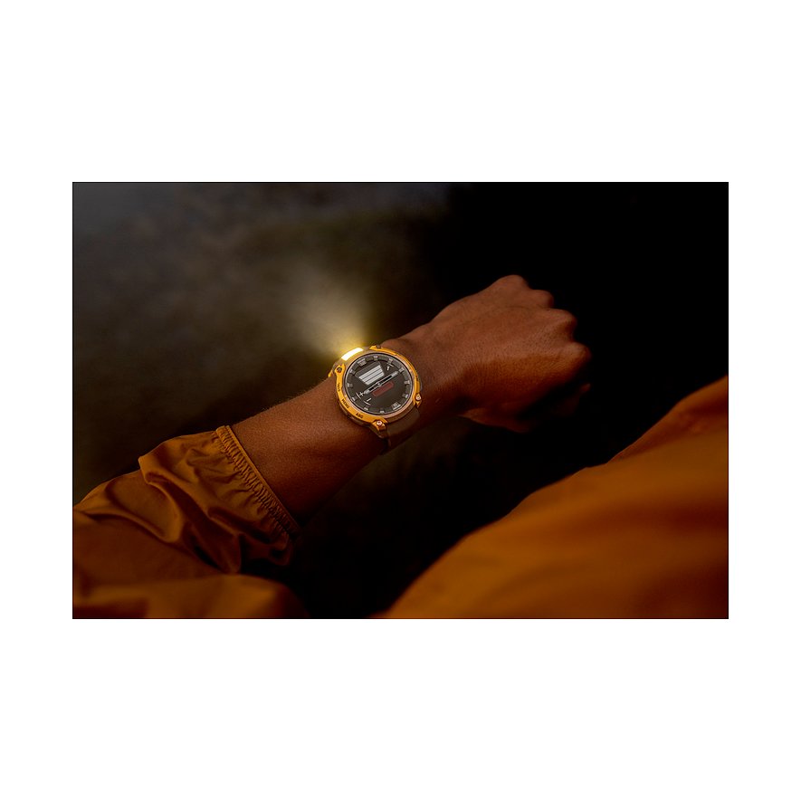 Eine Garmin Smartwatch aus Kunststoff mit goldfarbenem Gehäuse am Handgelenk eines Trägers, die ein helles Licht ausstrahlt.