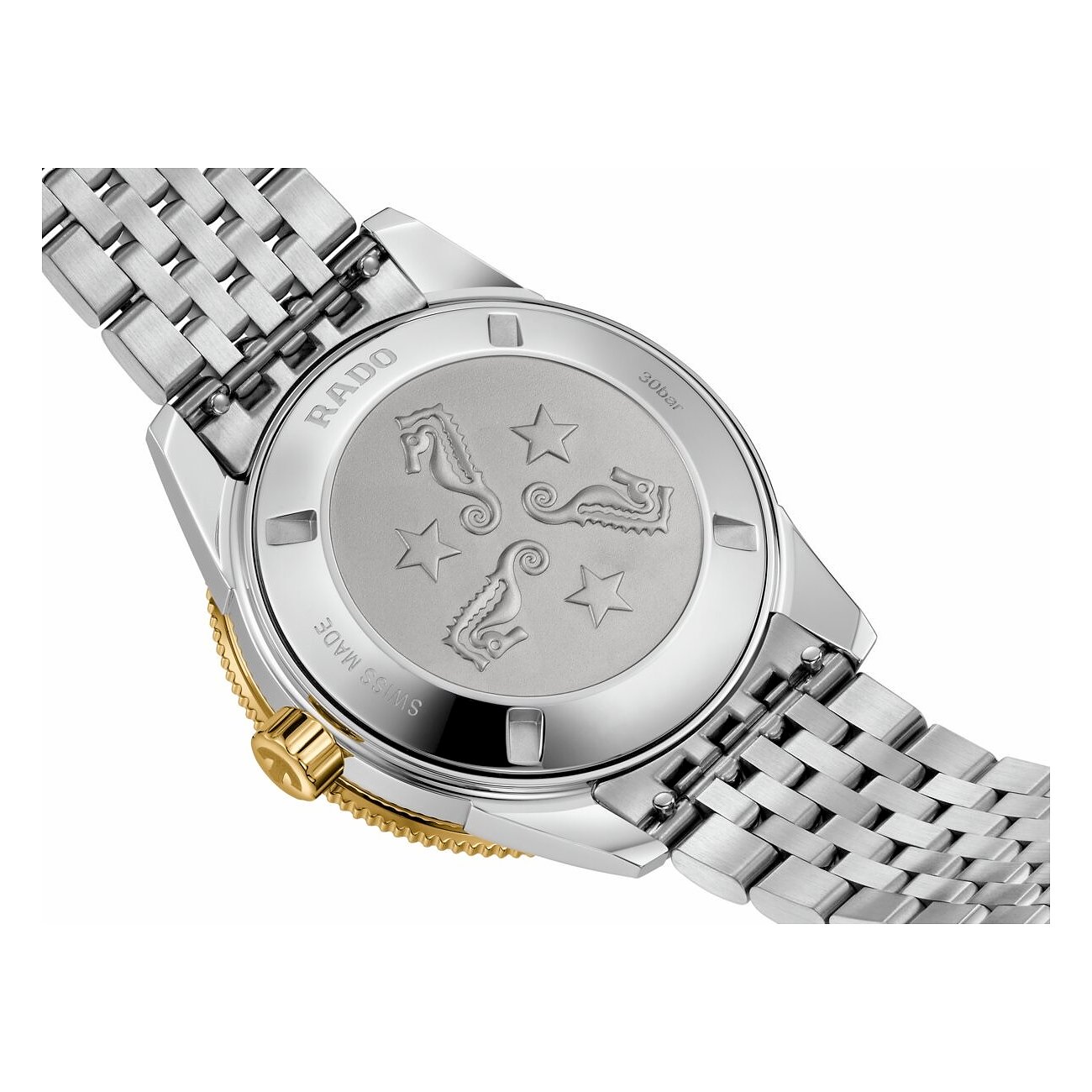 Rado Herrenuhr aus Edelstahl, Rückseite mit eingravierten Seepferdchen und Sternen, goldener Lünette und Krone.