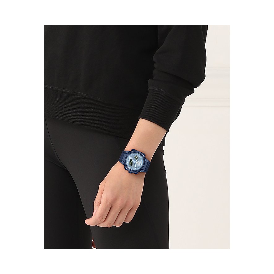 Am Handgelenk einer Person ist eine Lacoste Damenuhr aus blauem Kunststoff und Edelstahl zu sehen.