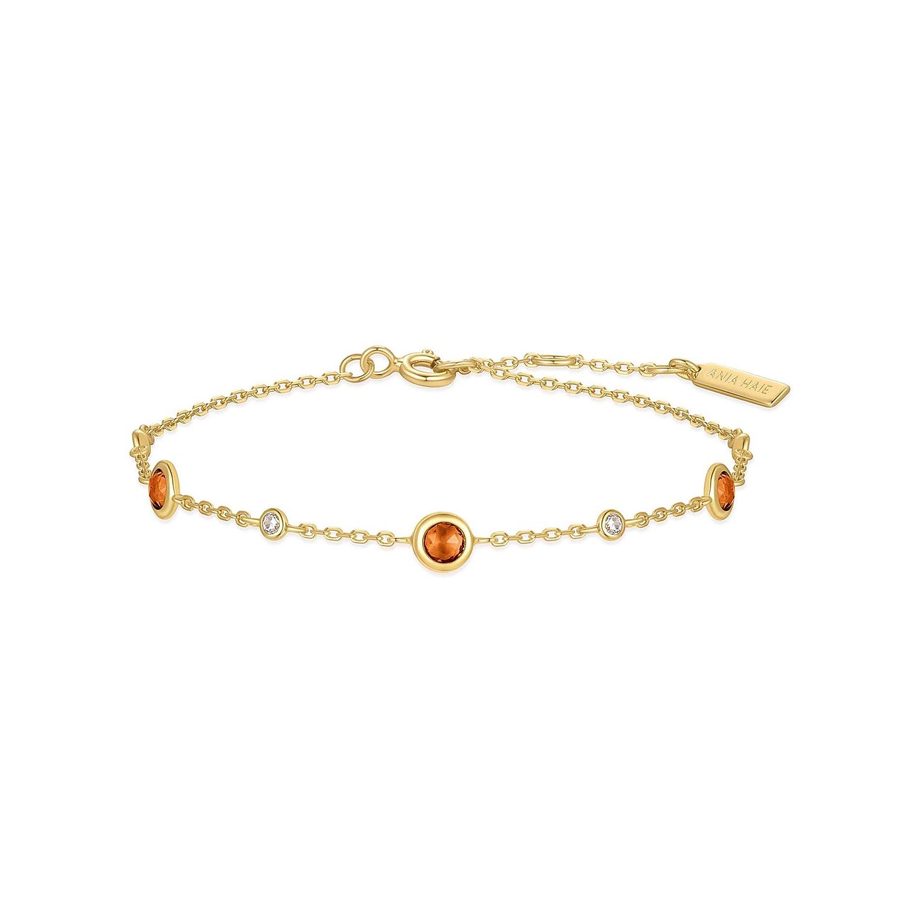 Ania Haie armbånd i forgyldt sølv med orange zirkonia farvede sten og klare smykkesten.