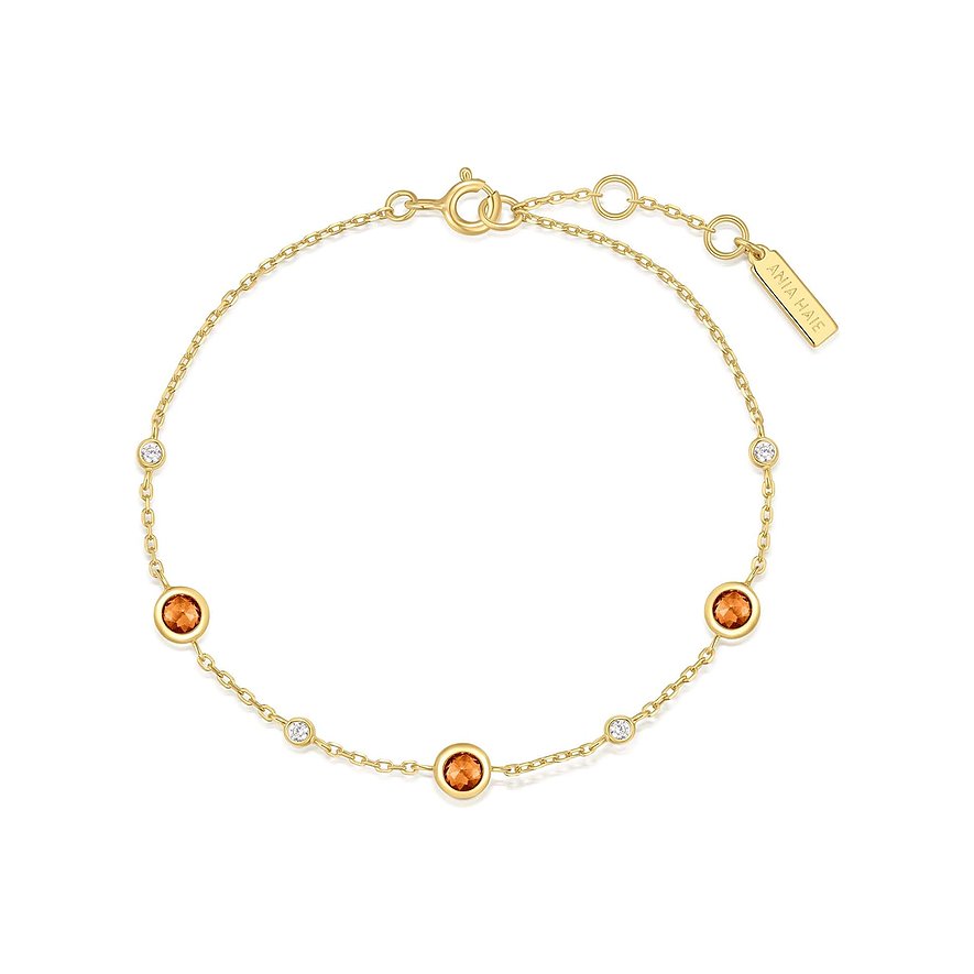 Ania Haie armbånd i forgyldt sølv med orange zirkonia og små, klare zirkonia sten.