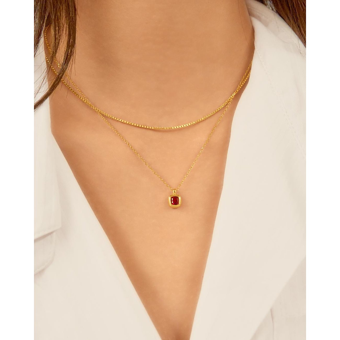 Collier Ania Haie en argent plaqué or avec zircon rouge, porté par un mannequin.