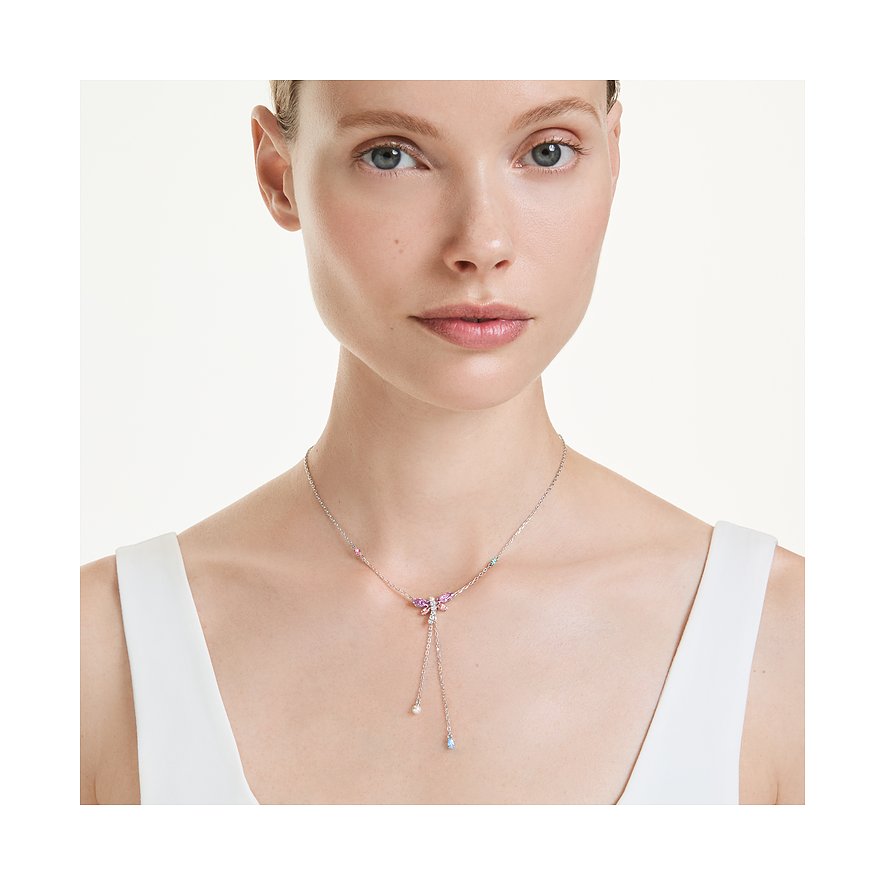 Model draagt een Swarovski metalen ketting met roze, blauwe en paarse vlindervormige kleurstenen.