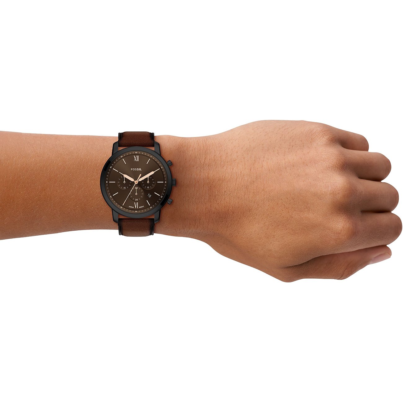 Am Arm getragene schwarze Fossil Herrenuhr mit braunem Lederarmband und Zifferblatt aus Edelstahl.
