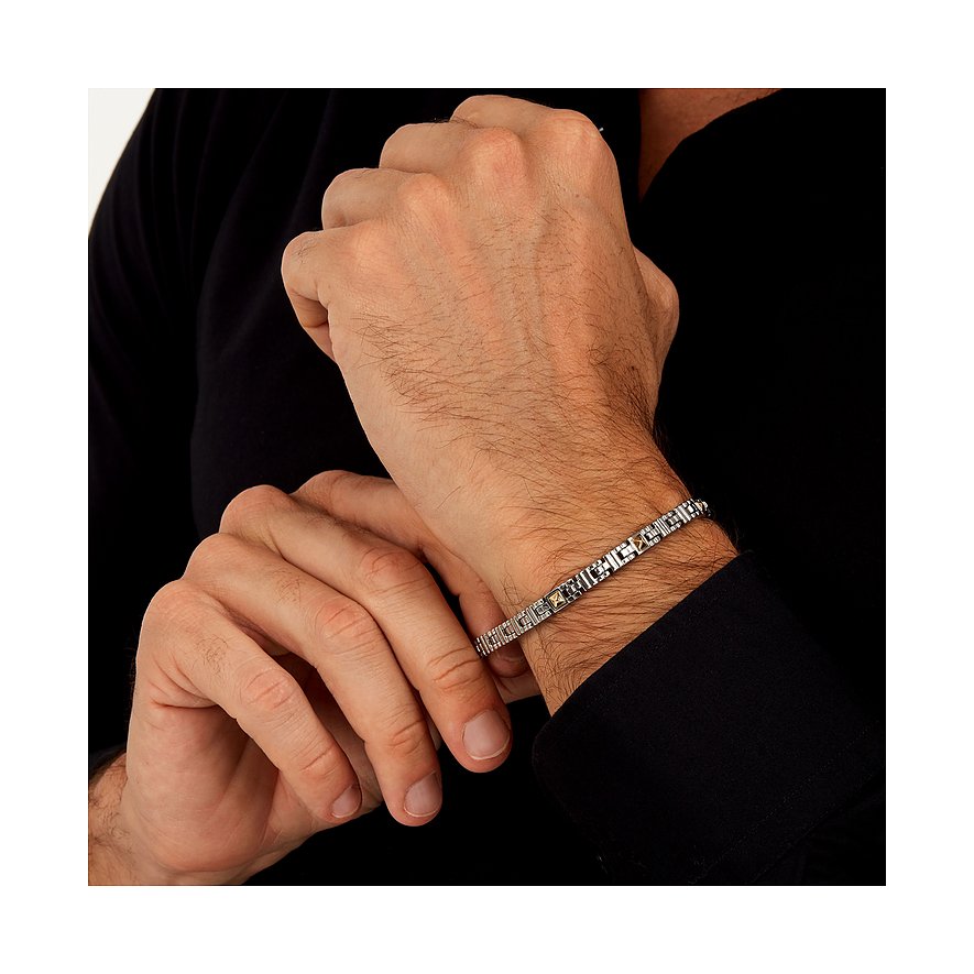 Morellato Armband aus Edelstahl und Gelbgold (750) an einem behaarten Arm, der ein schwarzes Hemd trägt.