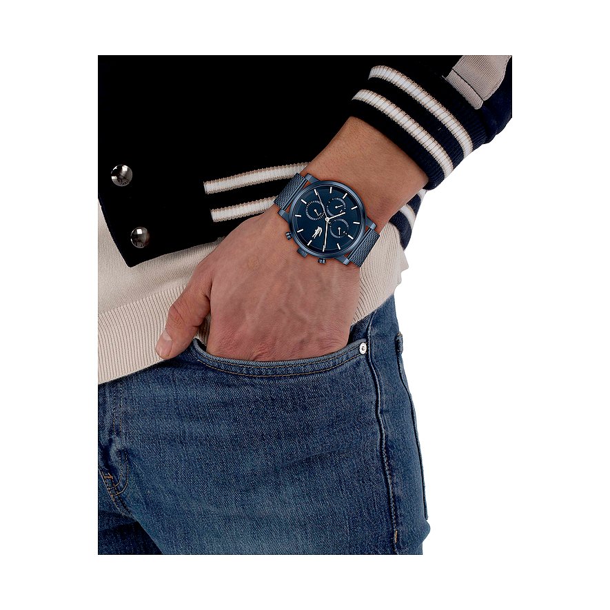 Blauw Lacoste herenhorloge van blauw roestvrij staal met blauwe wijzerplaat, gedragen om de pols van een man.