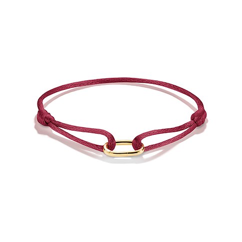 Thomas Sabo Armband aus rotem Textilband mit einem goldenen, ovalen Silber-Element in der Mitte.
