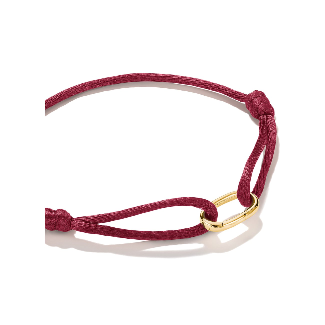 Bracciale Thomas Sabo: nastro tessile rosso con elemento ovale centrale in argento dorato.