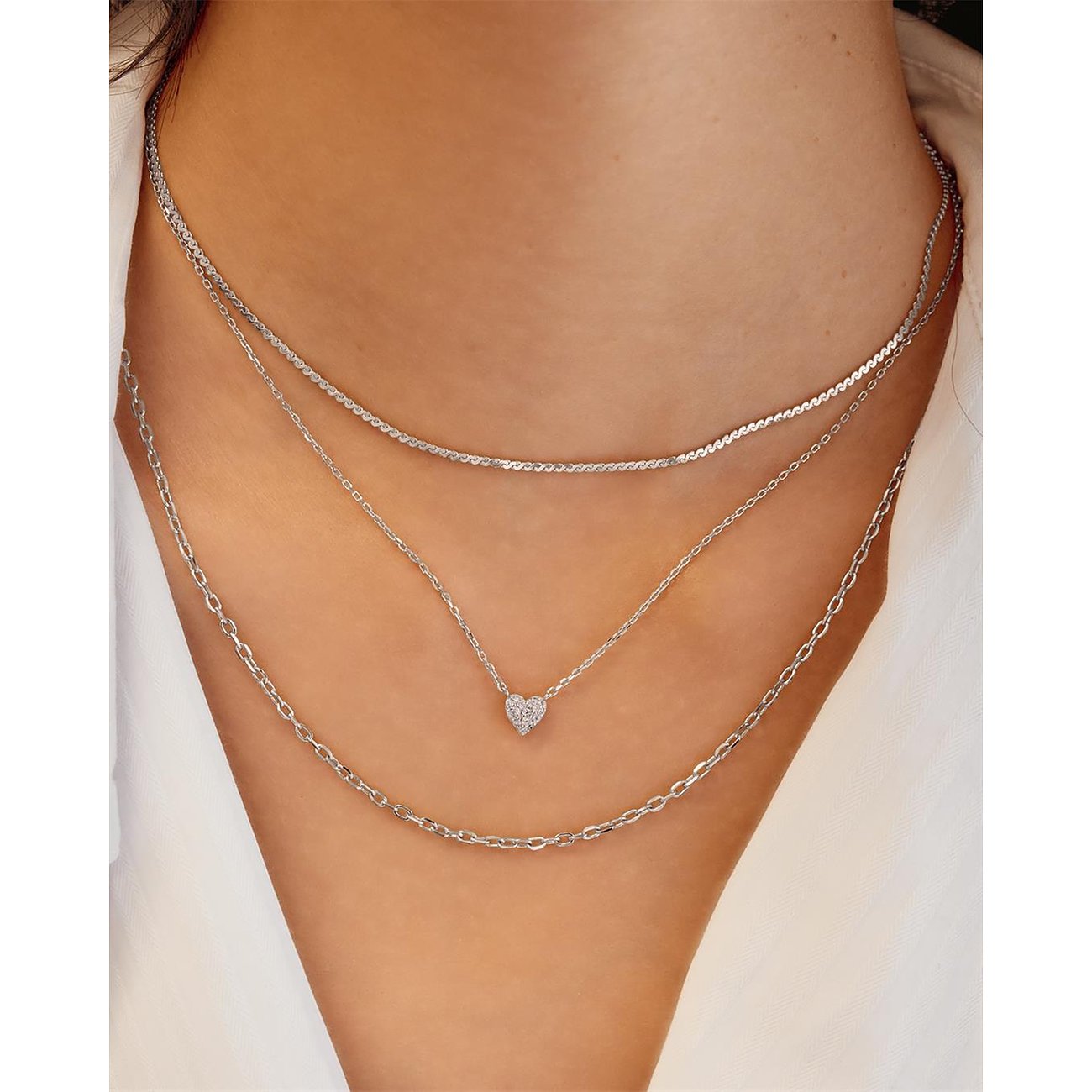Ania Haie 925 zilveren drielaagse ketting. De middelste ketting heeft een sprankelende zirkonia hart hanger.