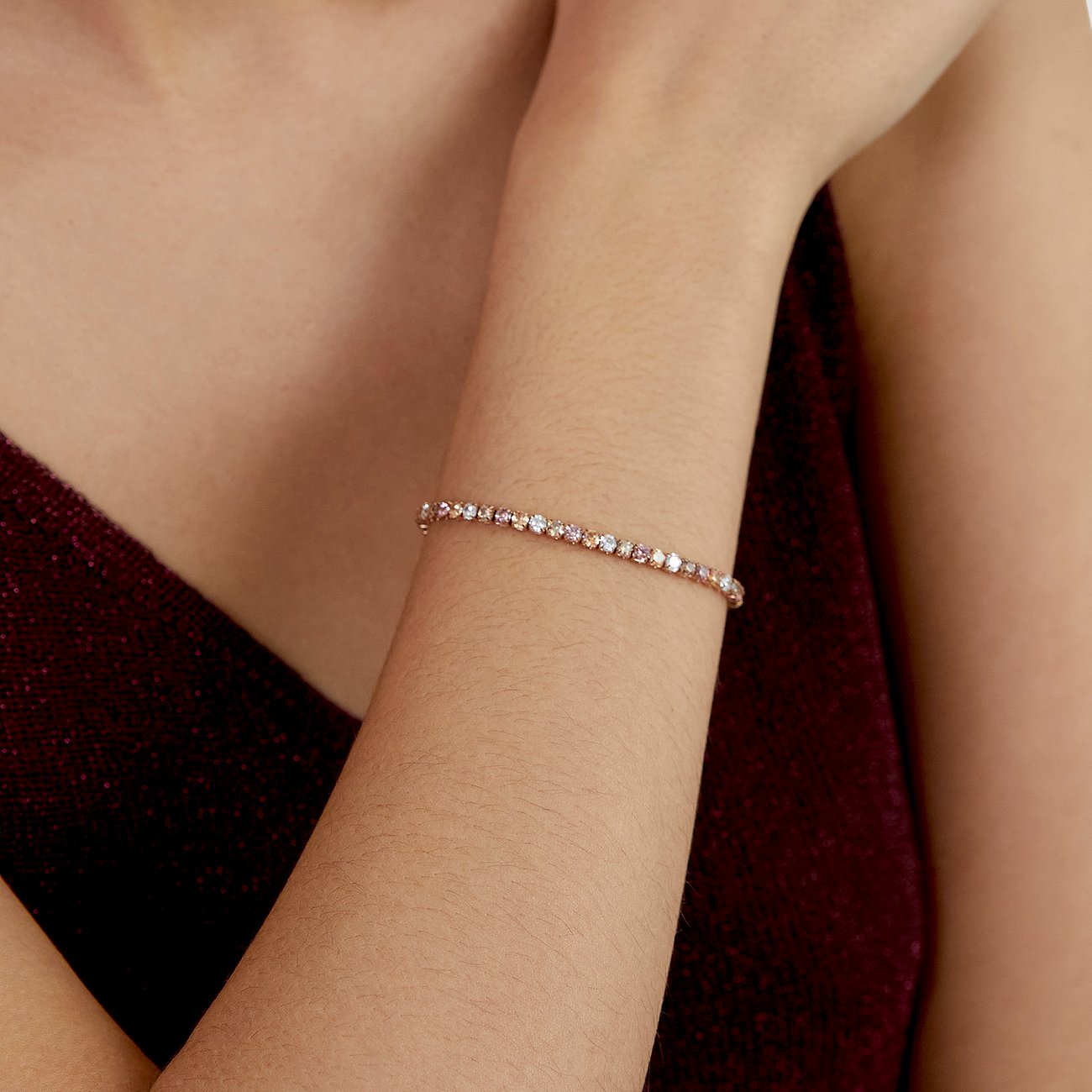 s.Oliver Armschmuck aus rosévergoldetem Edelstahl mit einer Reihe bunter Zirkonia-Farbsteine am Handgelenk getragen.