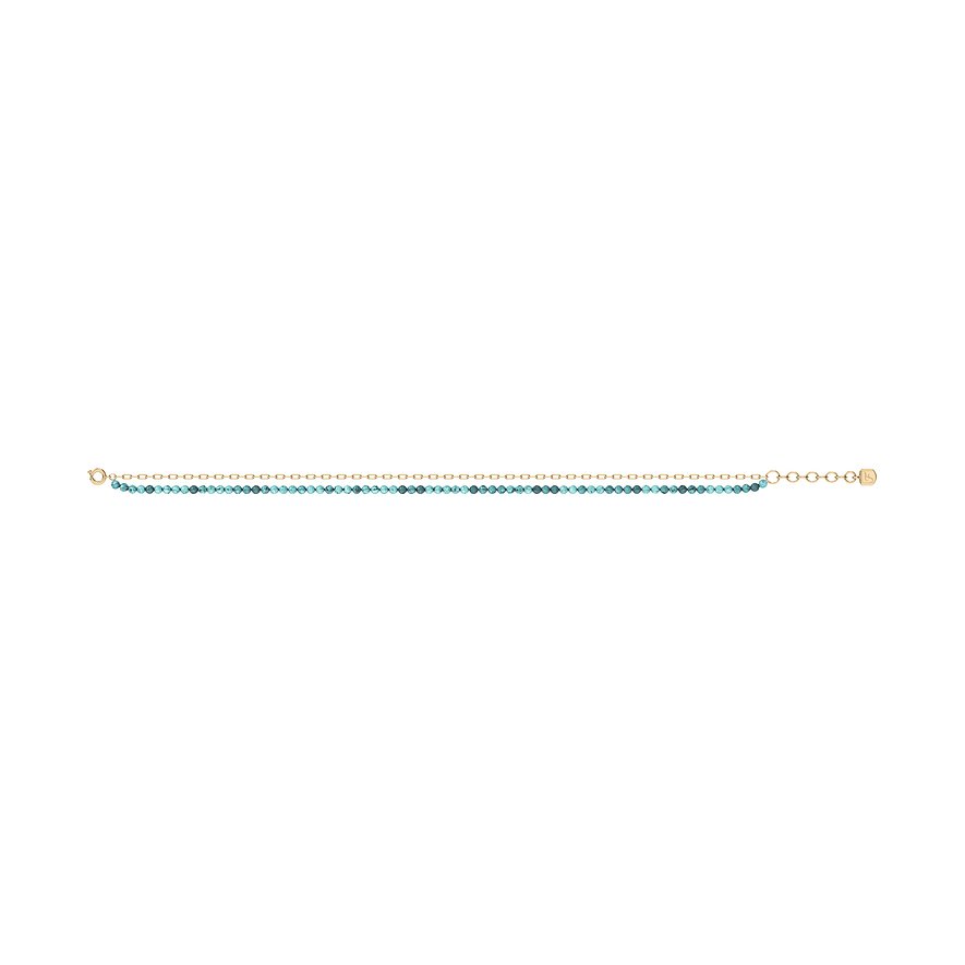 Un bracciale Fossil in acciaio inossidabile color oro con una fila di piccole pietre decorative turchesi.