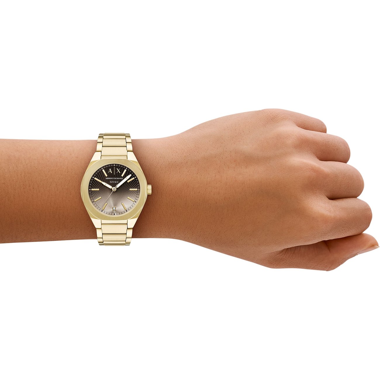 Eine Armani Exchange Damenuhr aus goldfarbenem Edelstahl mit dunkelgrauem Zifferblatt ziert ein Handgelenk.