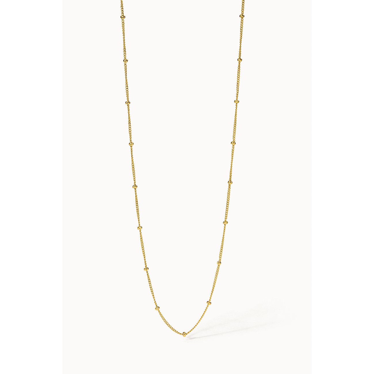 Purelei ketting van goudkleurig roestvrij staal met kleine ronde kralen langs de ketting, van bovenaf.